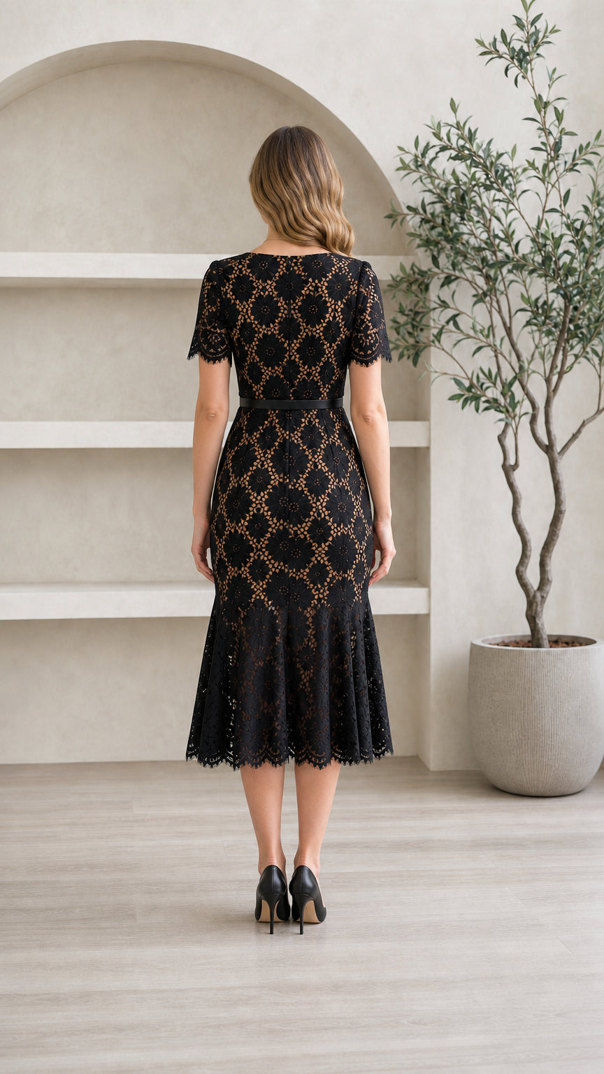 Back view of model wearing black short sleeve lace midi dress