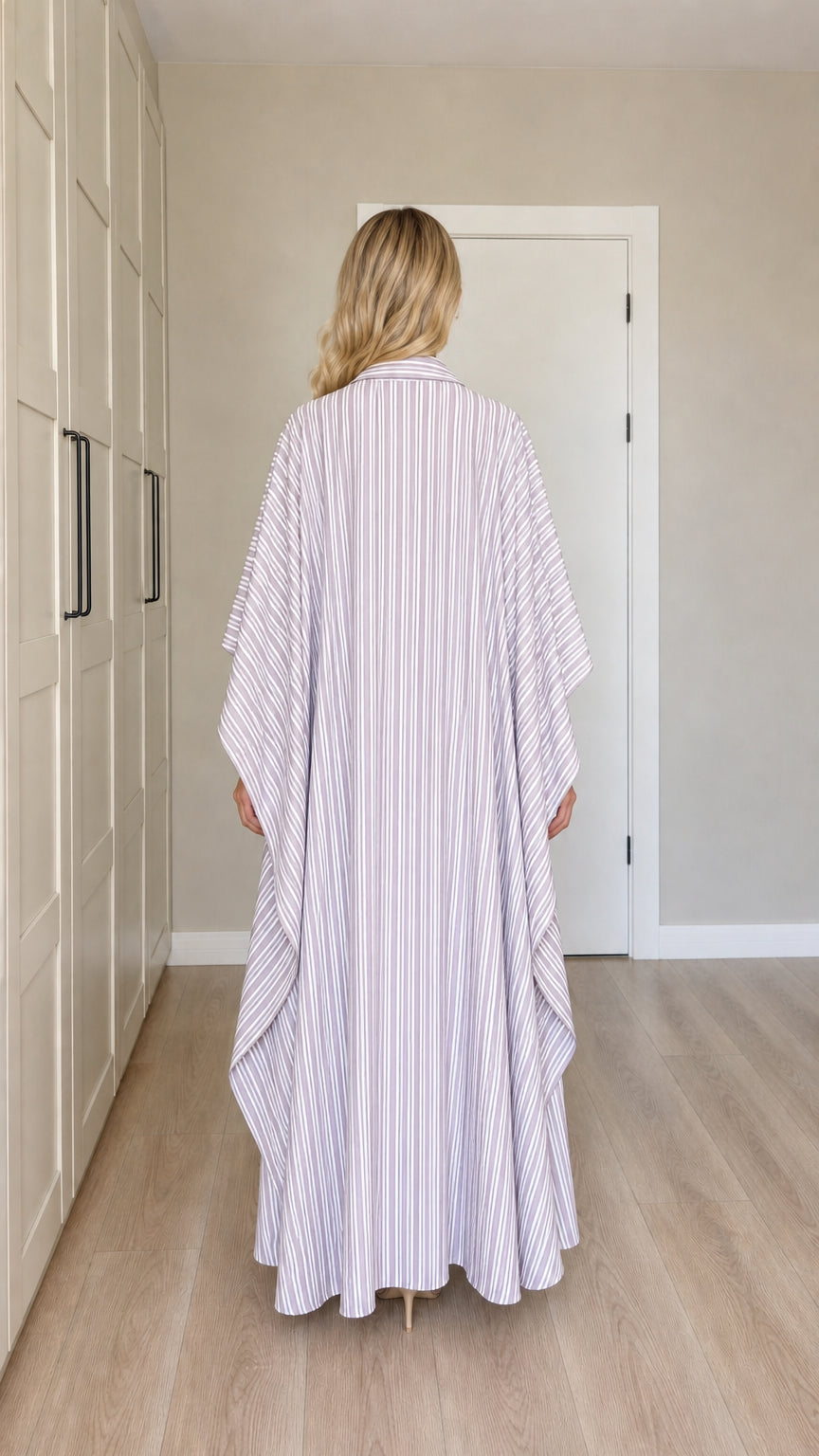 Back view of woman wearing lavender vertical striped maxi kaftan dress
