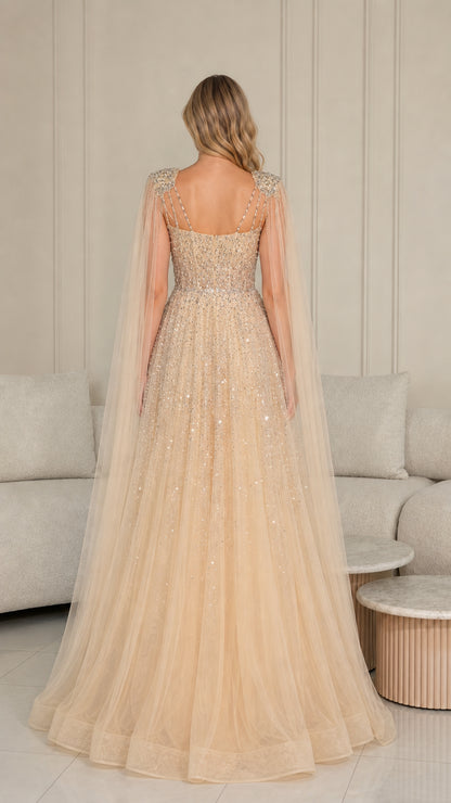 Back view of champagne floor-length evening gown showing flowing tulle cape