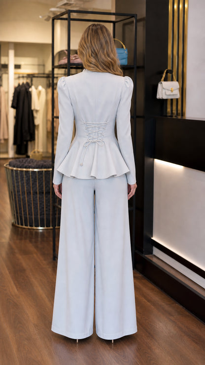 Back view of light blue peplum jacket showing corset-style lace up detail