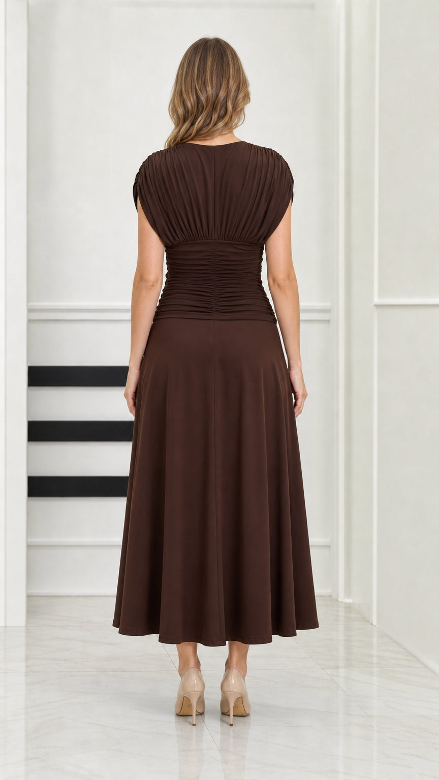 Back full-length view of model wearing chocolate brown ruched back midi dress