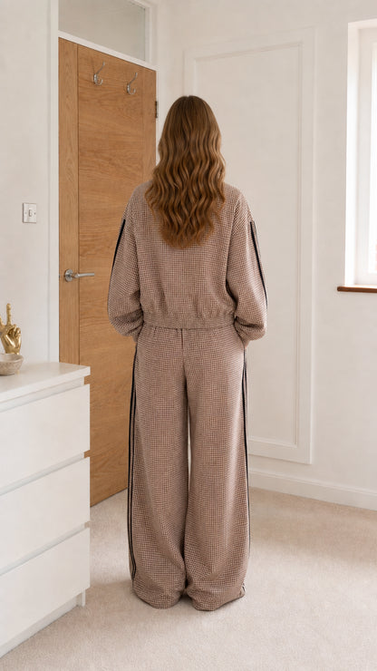 Taupe gingham jumpsuit shown from the back with elastic waist and full-length legs