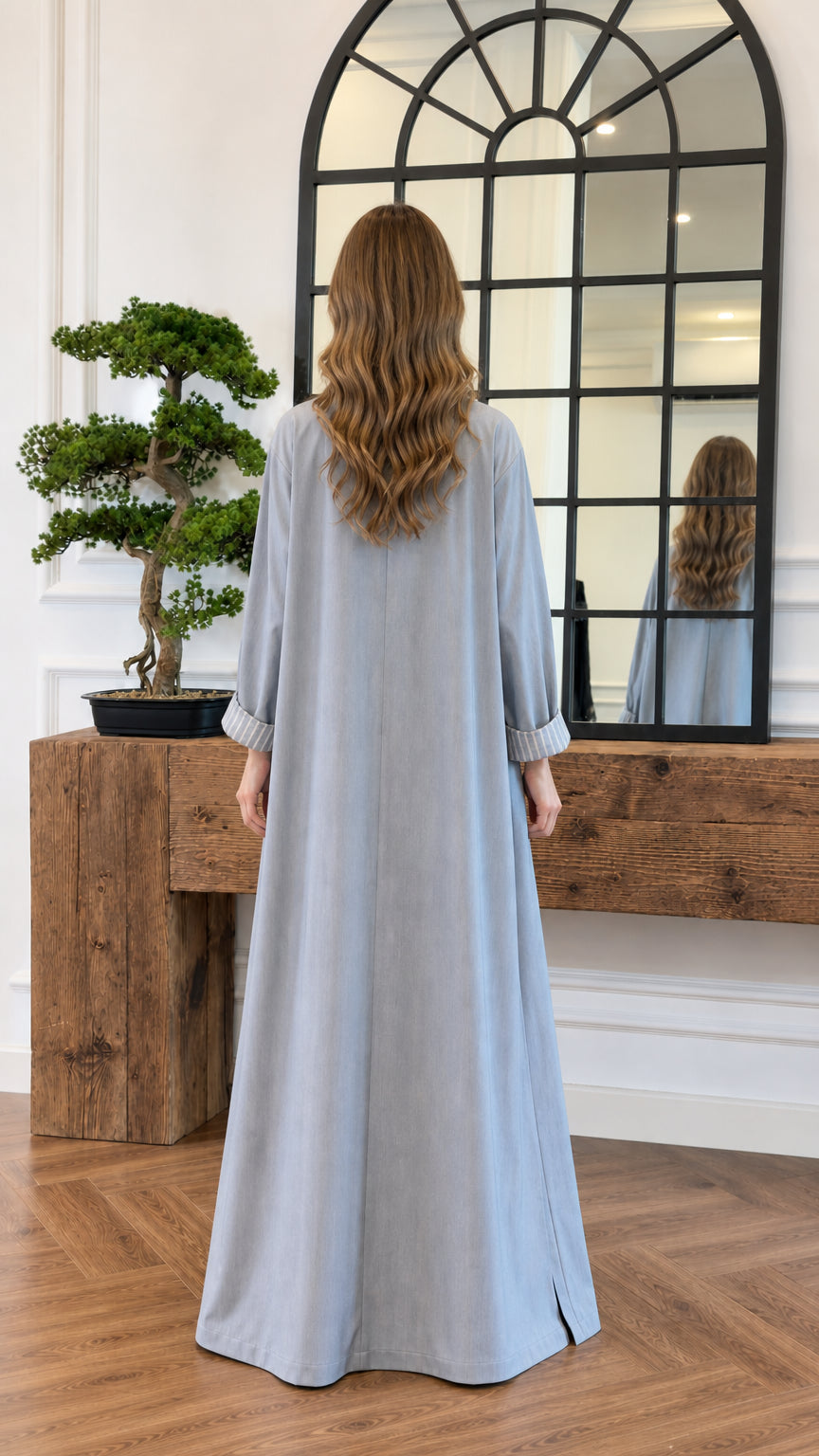 Back view of the flowing floor-length light blue duster coat