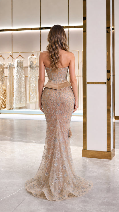 Back full-length view of champagne strapless evening gown with subtle sweep train