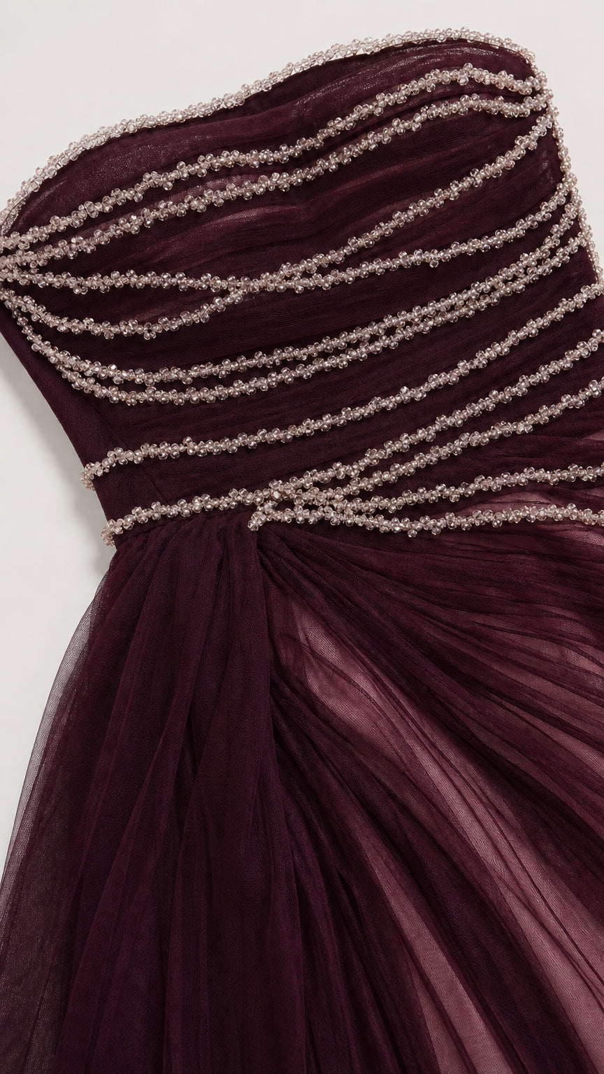 Close-up detail of the hand-beaded horizontal strands and ruched tulle bodice texture