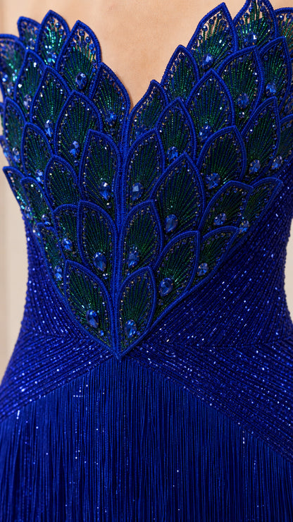 Close-up of intricate peacock feather beaded embroidery on gown bodice