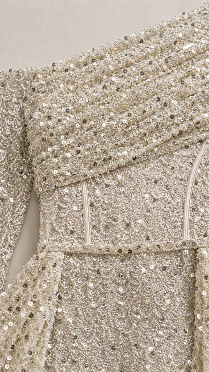 Close-up detail of champagne sequin fabric and corset bodice boning