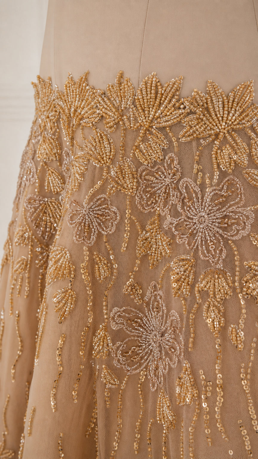 Close-up detail of intricate gold floral beadwork and sequin embroidery
