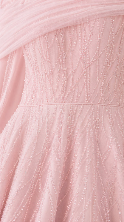 Close-up detail of blush pink textured linear embroidery on tulle fabric