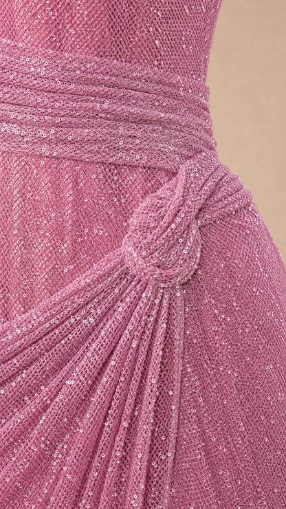 Close-up detail of shimmering textured fabric and gathered knot waist detail