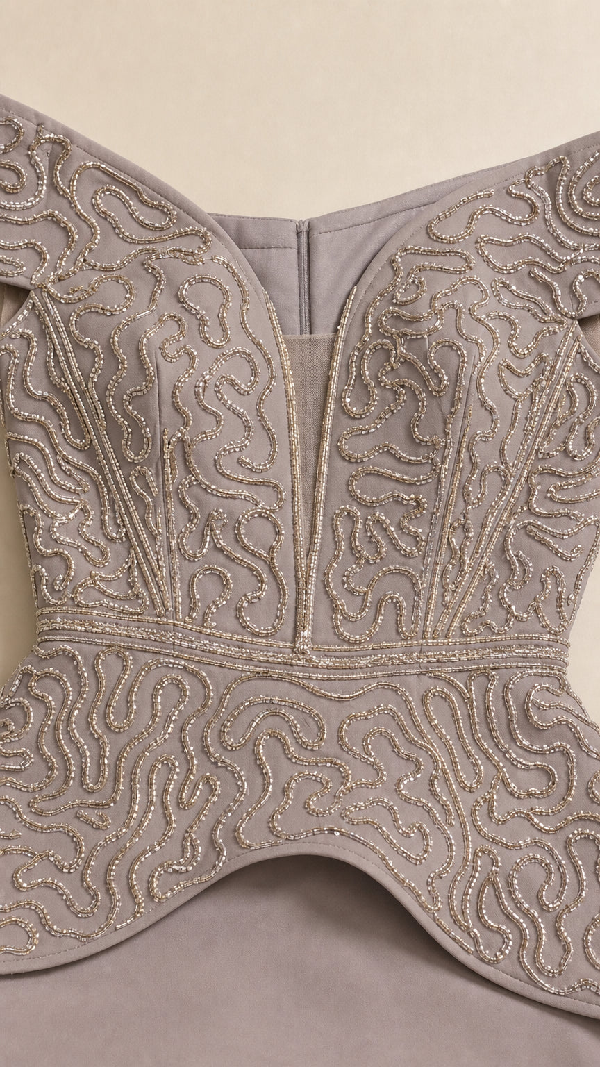 Close-up detail of swirl beaded embroidery and illusion plunge neckline on bodice