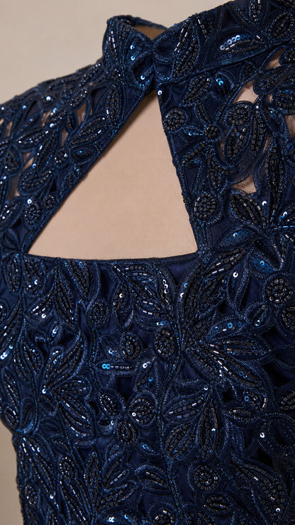 Close up detail of navy blue beaded lace embroidery and keyhole collar