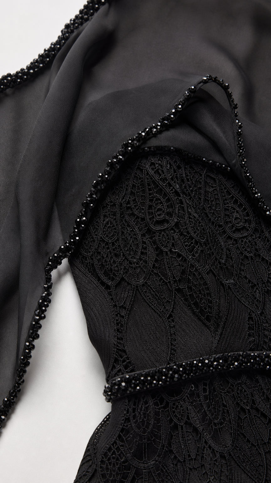 Close-up detail of textured leaf lace overlay and delicate beadwork trim