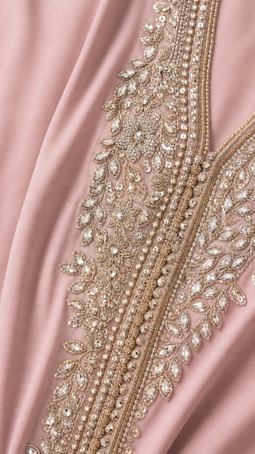 Close-up detail of intricate rhinestone and bead embroidery on neckline