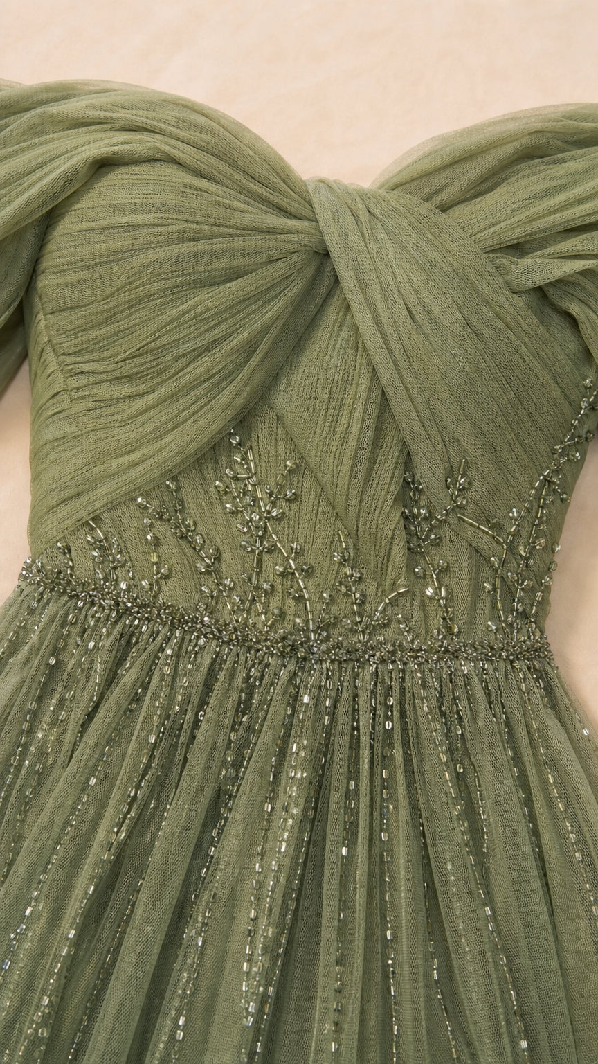 Close-up detail of pleated tulle bodice and intricate beading on sage green dress