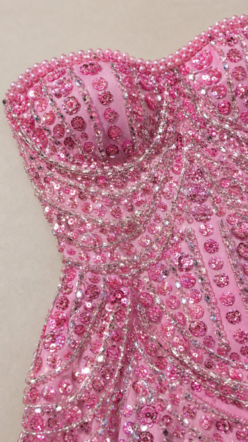 Detailed close-up of pink sweetheart bodice with intricate bead and sequin craftsmanship