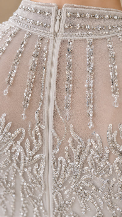 Close-up detail of illusion beaded neckline and zipper on formal gown