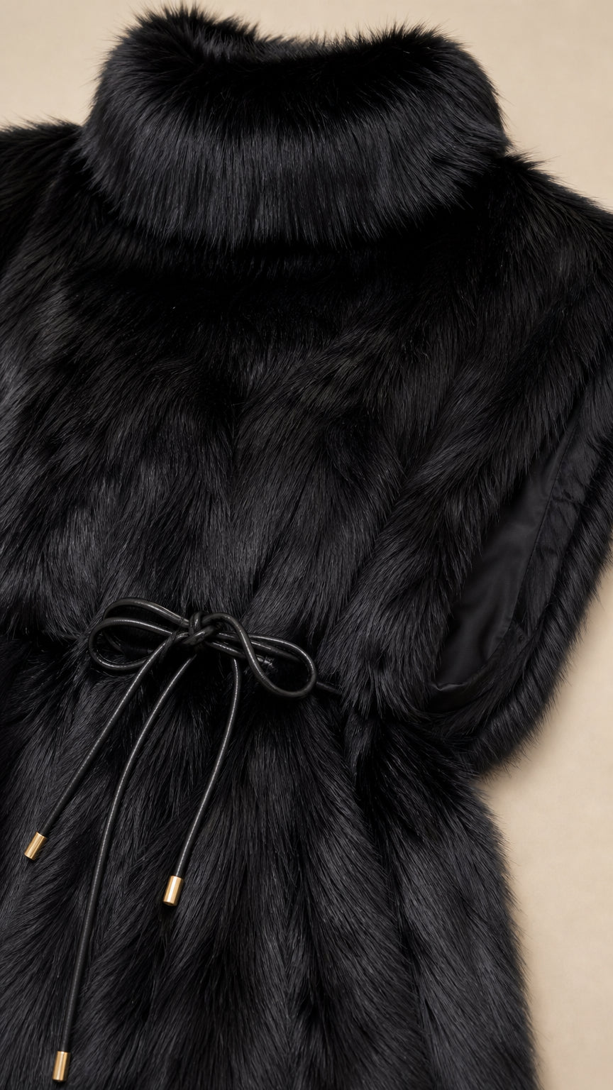 Close-up detail of plush black faux fur texture, high collar, and front tie with metal aglets
