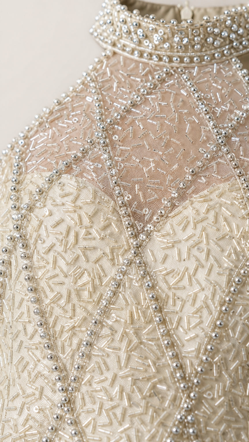 Close-up detail of illusion neckline and intricate geometric beadwork on collar