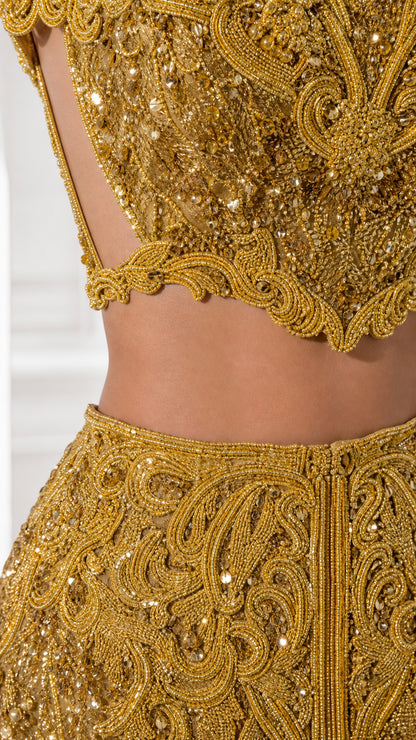 Close-up detail of intricate gold beadwork, sequins, and scalloped edges
