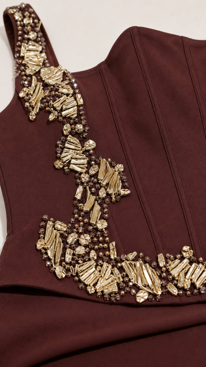 Close-up detail of gold and crystal beaded embroidery on chocolate brown bodice