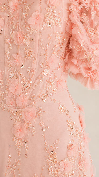 Close-up detail of 3D floral petals and sequin embroidery on blush pink gown
