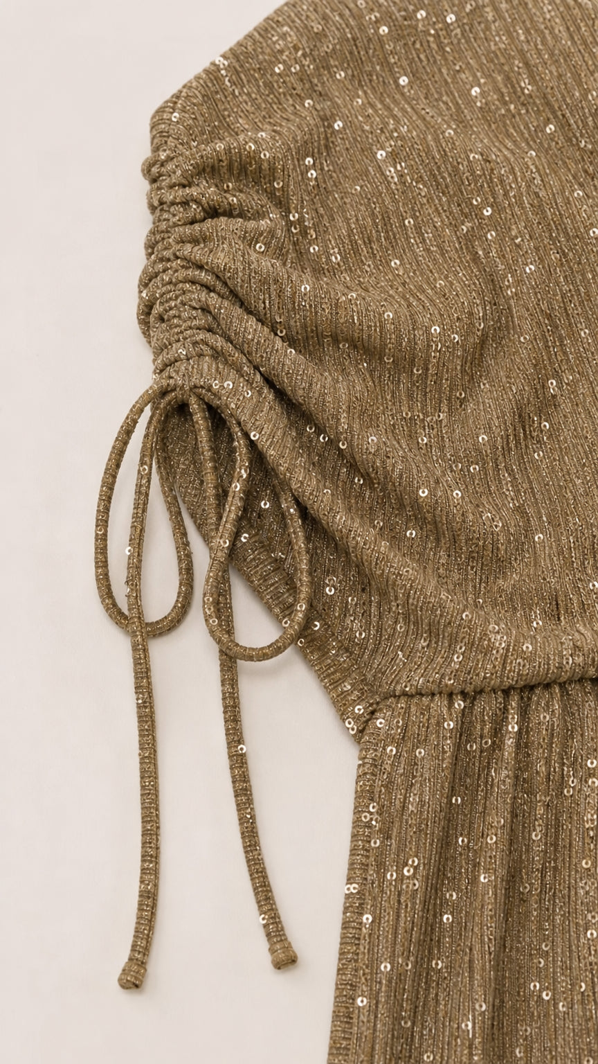 Close-up detail of Champagne Gold sequin fabric with adjustable ruched drawstring sleeve