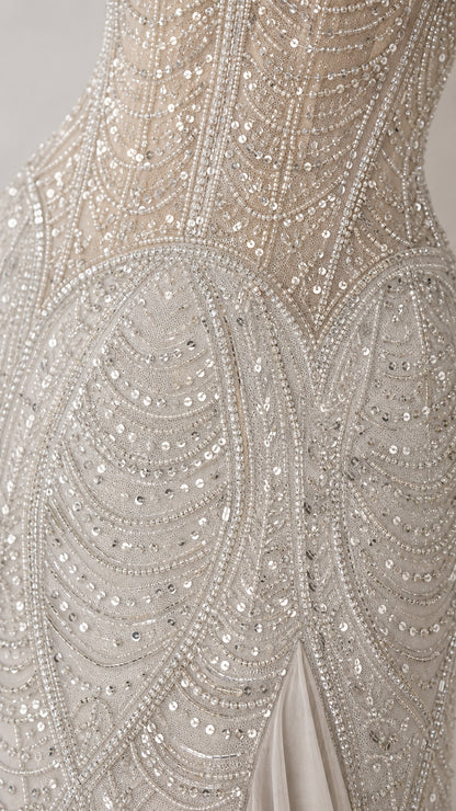 Close-up of intricate silver beadwork and sequin embroidery on bodice