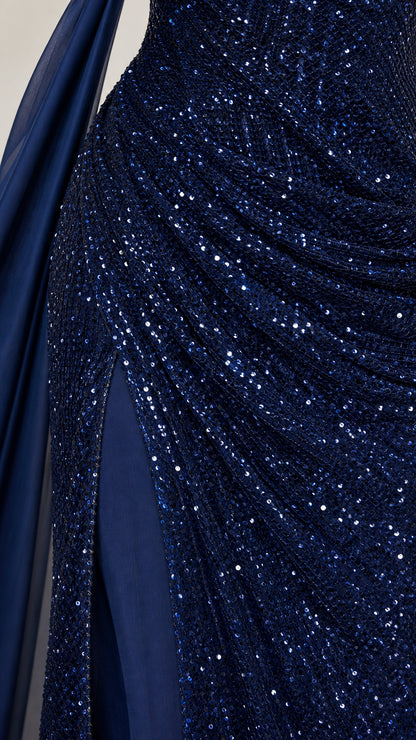Close-up texture view of intricate navy blue sequins and ruched fabric craftsmanship