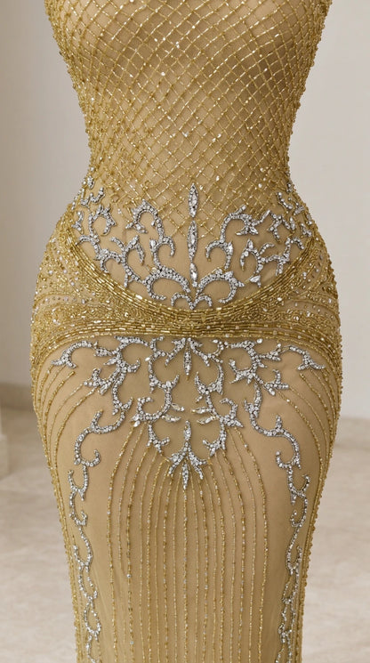 Close-up detail of ornate beadwork and sequin embellishments on gold evening dress