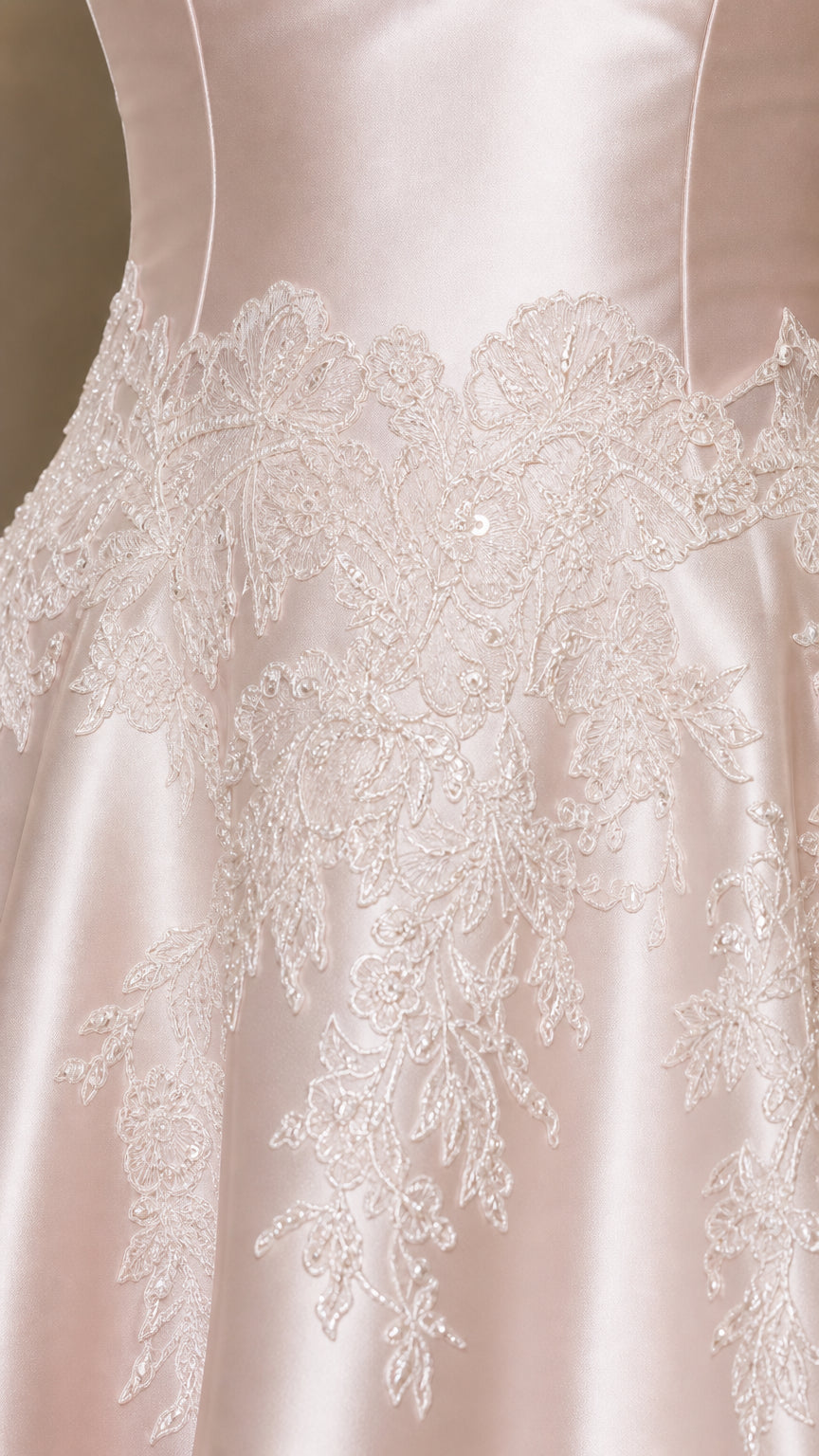 Close-up detail of delicate floral lace embroidery on satin dress