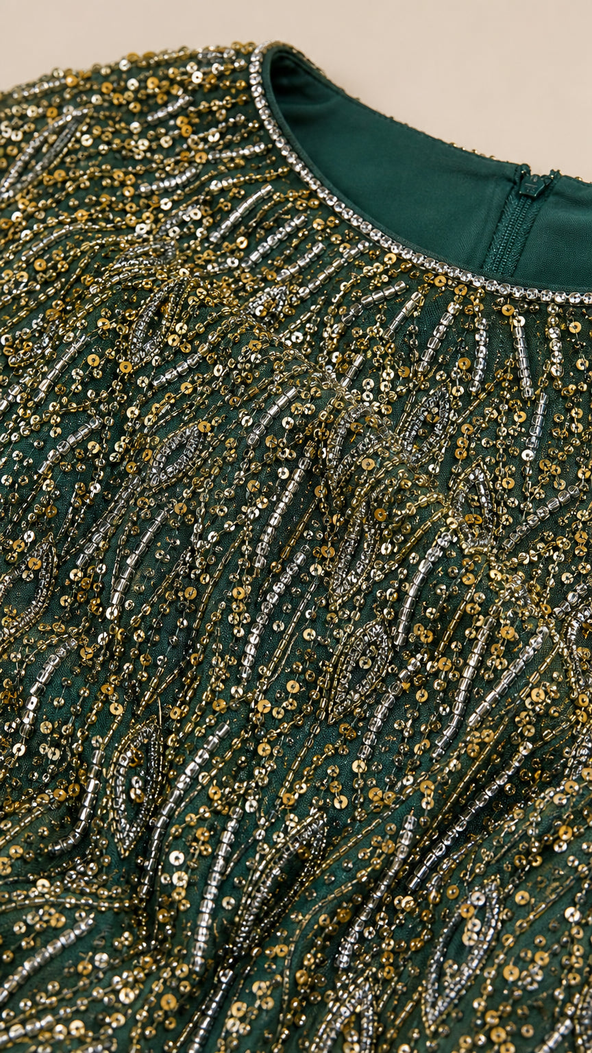 Close-up detail of neckline and shimmering sequin embroidery on evening dress