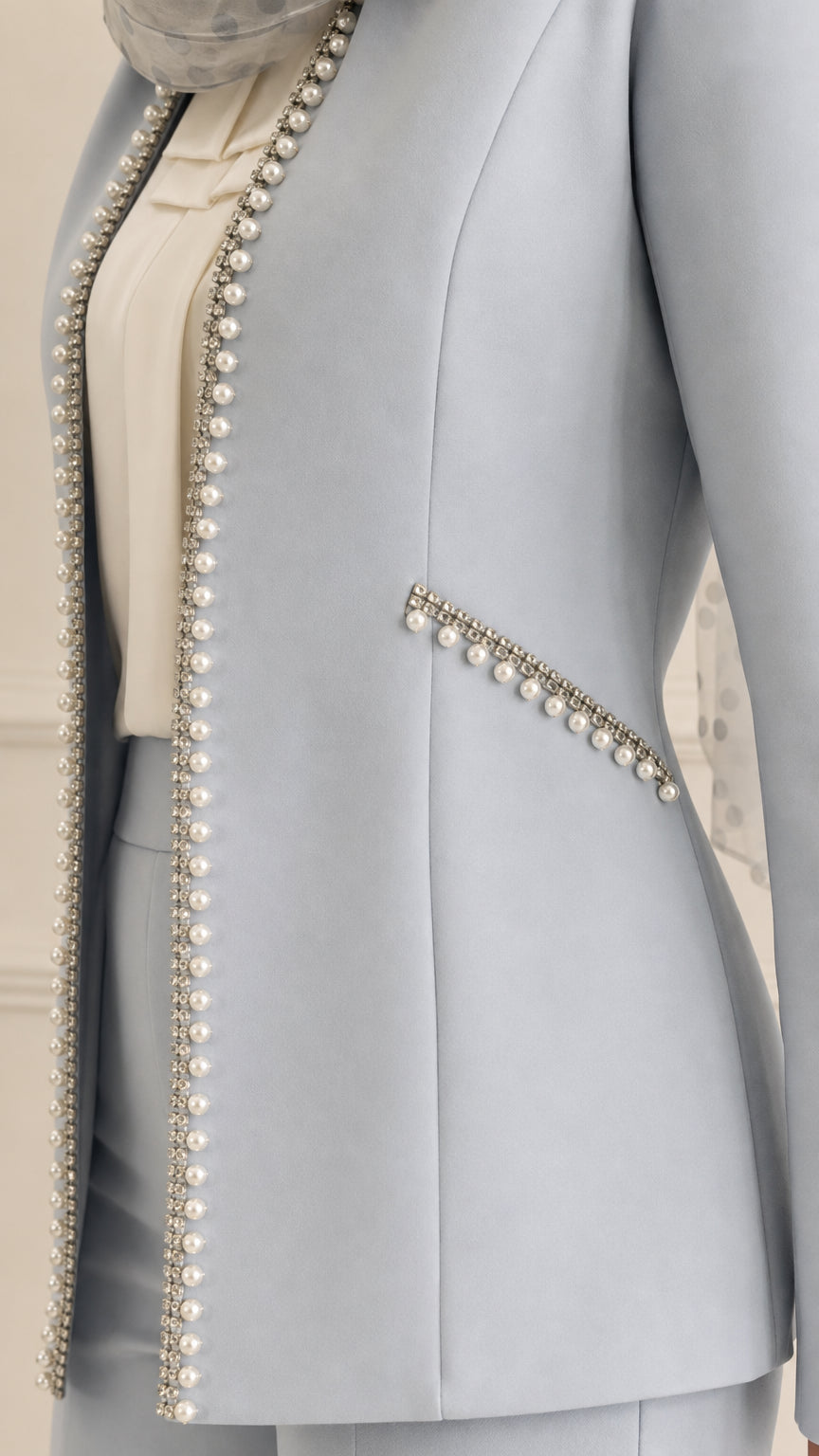 Close up of pearl bead embellishments along jacket placket and side pocket trim