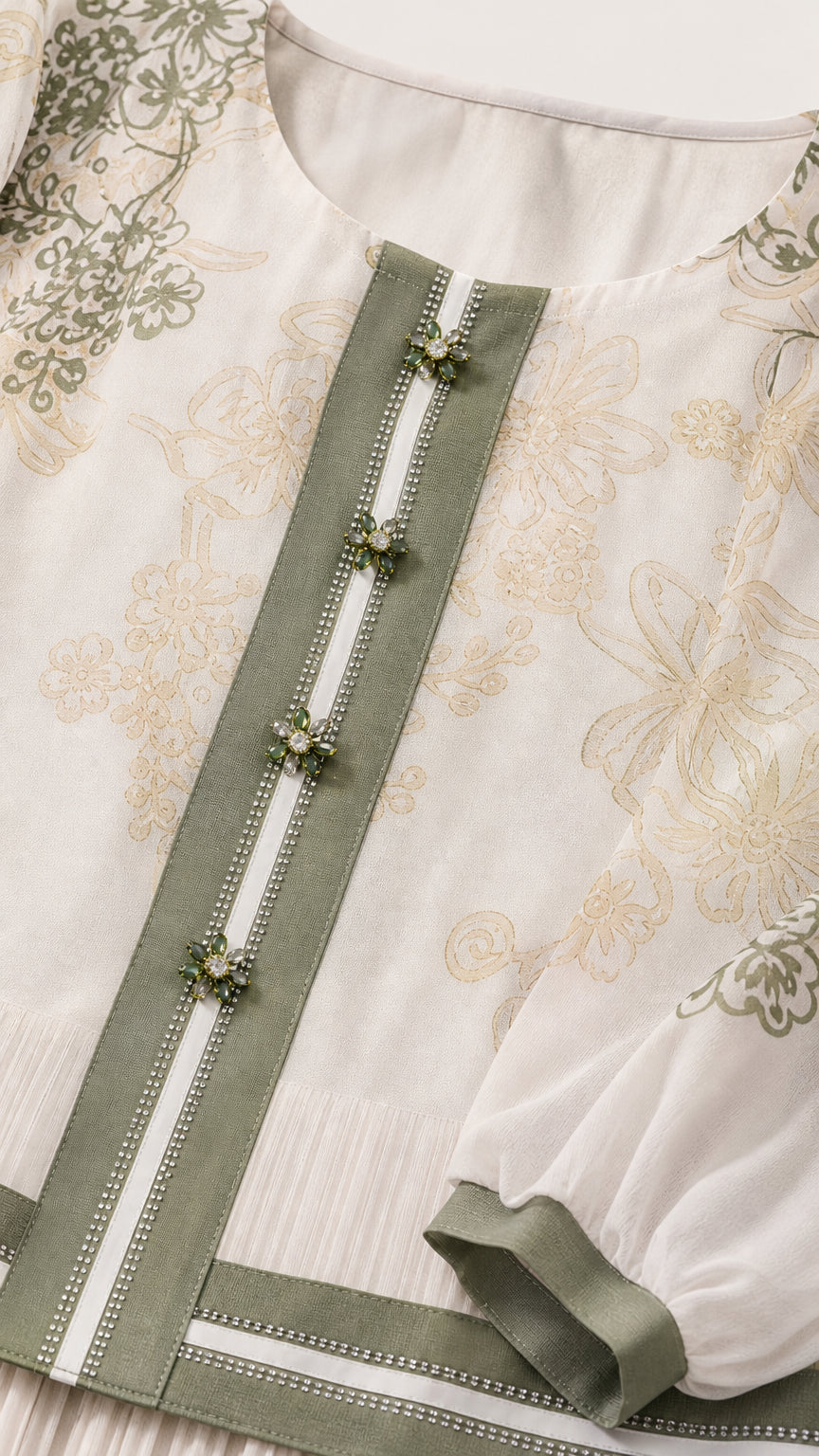 Close-up detail of cream blouse placket with contrast trim and embellishments