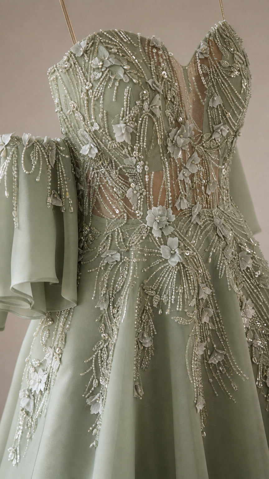 Close-up of intricate 3D floral appliqués and beadwork on sage green bodice