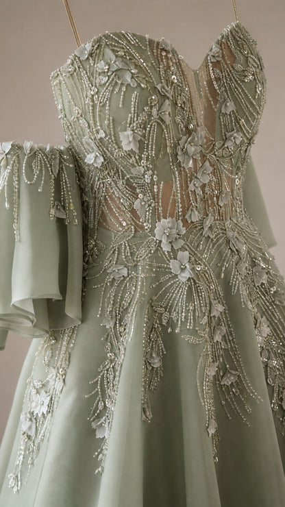 Close-up of intricate 3D floral appliqués and beadwork on sage green bodice