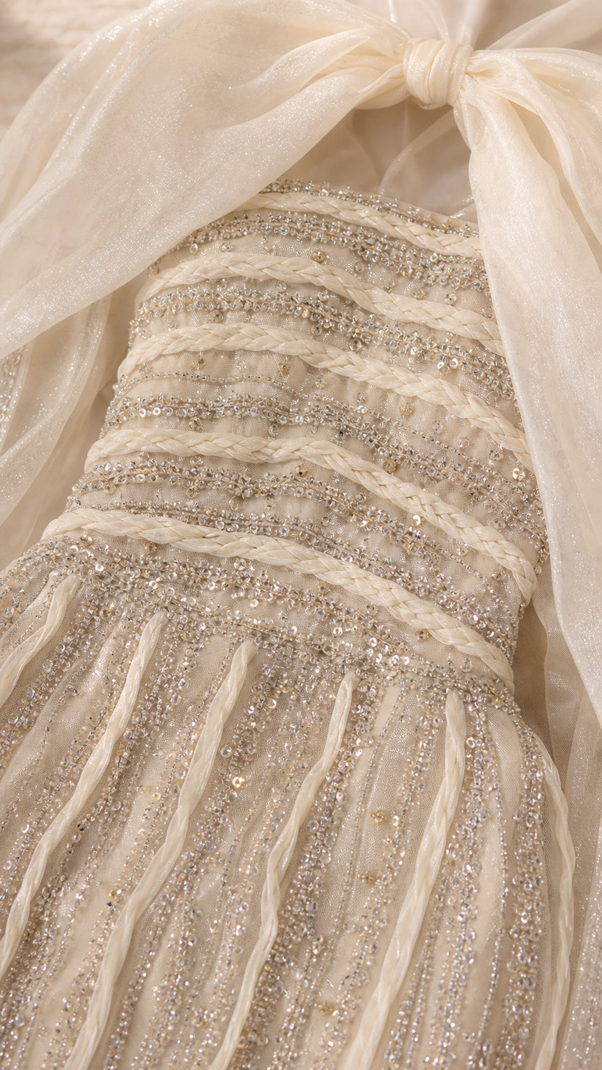Detailed close-up of braided neckline trim and linear sequin and bead embellishments