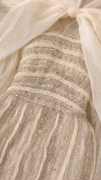 Detailed close-up of braided neckline trim and linear sequin and bead embellishments