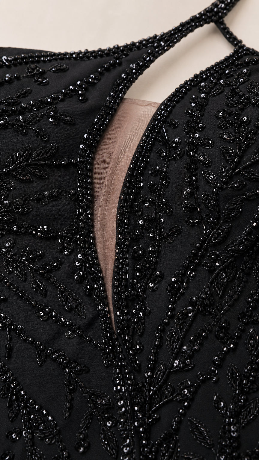 Close-up detail of beaded floral embellishments and sheer mesh cutout