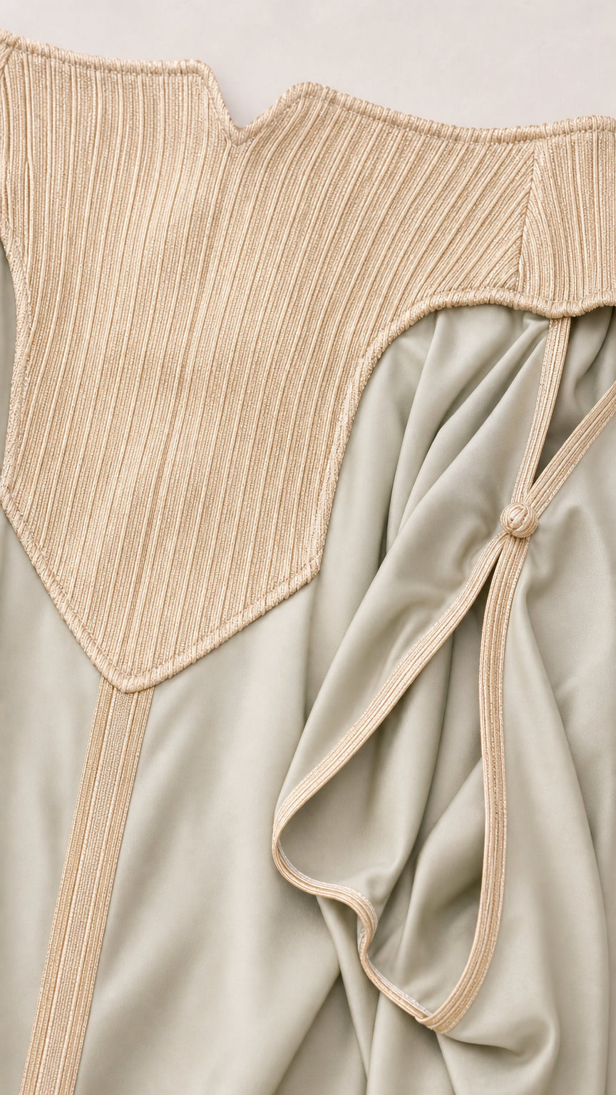 Close-up detail of textured ribbed neckline and fabric piping trim