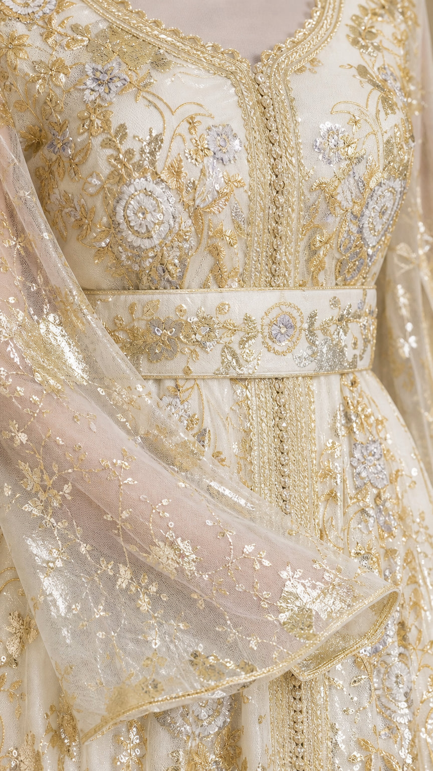 Close-up detail of metallic floral embroidery, V-neckline, belt, and sheer bell sleeve