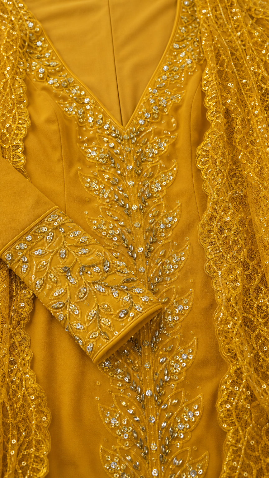 Close-up detail of leaf sequin embroidery on neckline, cuffs, and lace trim
