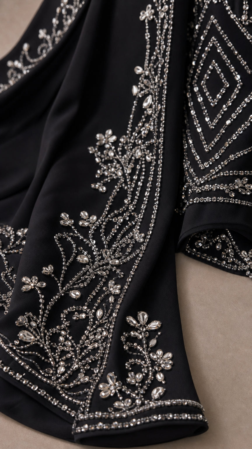 Close-up detail of the intricate crystal beading, silver embroidery, and mesh fabric
