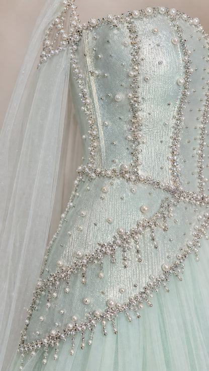 Close-up detail of mint green gown bodice with pearl and bead embellishments