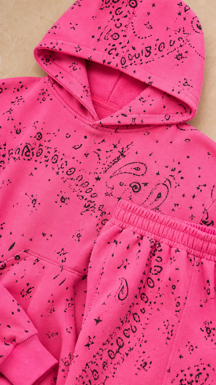 Close-up detail of Hot Pink paisley print hood, kangaroo pocket, and elastic waistband