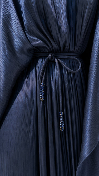 Close-up detail of pleated shimmer texture and beaded tie waist cord