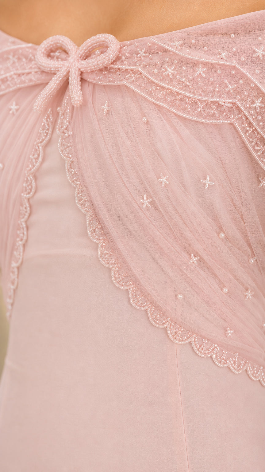 Close-up detail of embroidered sheer capelet with bead accents and bow