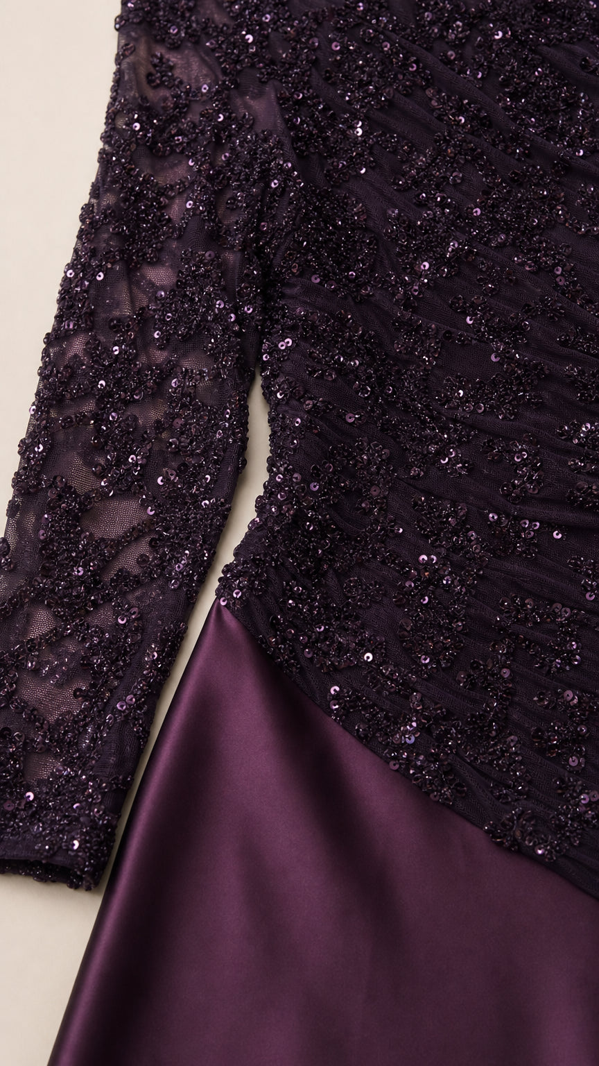 Close-up of plum beaded sequin lace bodice and smooth satin skirt texture
