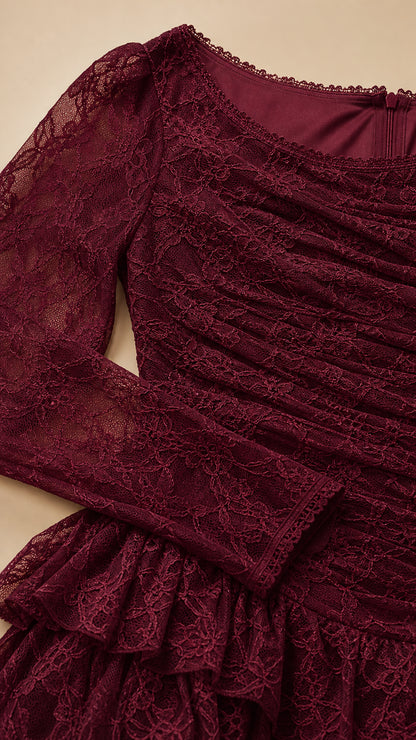 Close-up of ruched floral lace bodice and tiered ruffle detailing in burgundy
