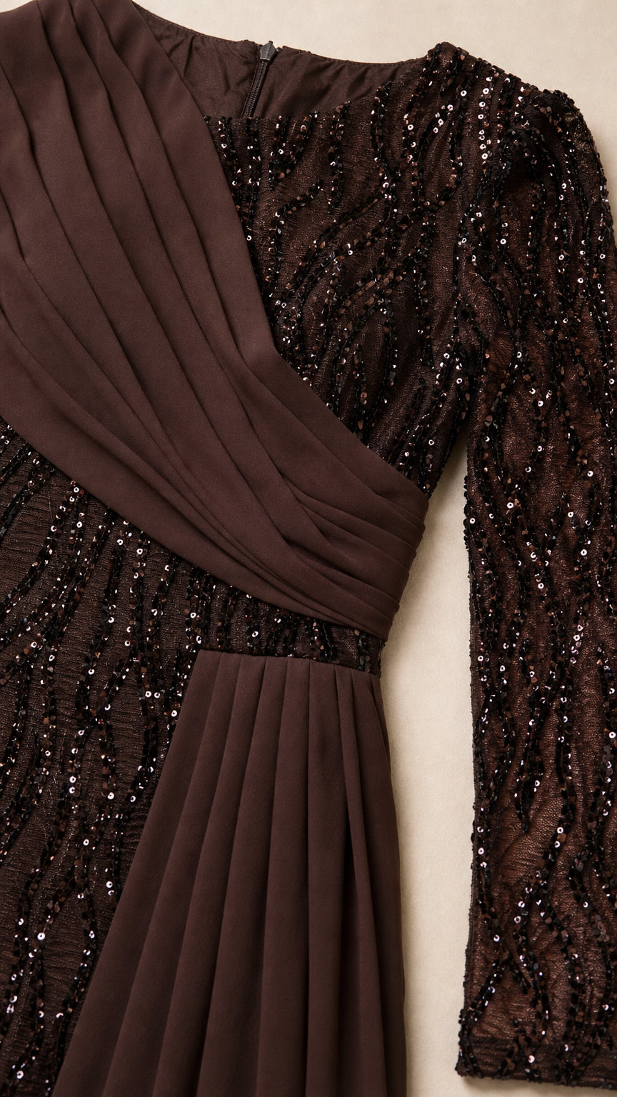 Close-up detail of chocolate brown sequin fabric and pleated chiffon waist drape